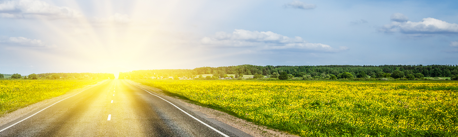 Sun flare in the distance on a road